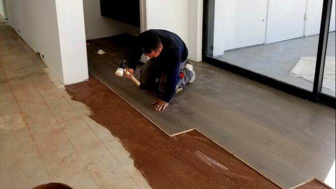 Handyman removing ceramic tiles